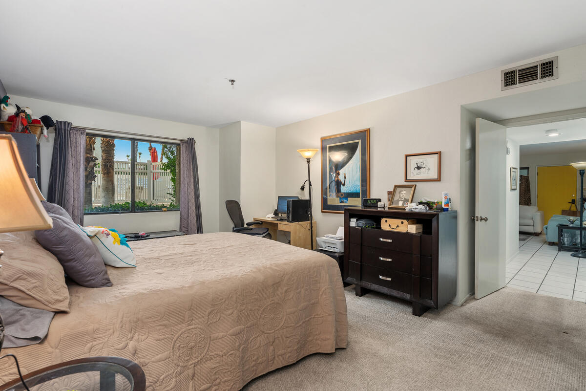 200 East Racquet Club Road, Unit 69 Palm Springs, CA 92262 - Photo 20 of 44 a bedroom with a bed and a dresser