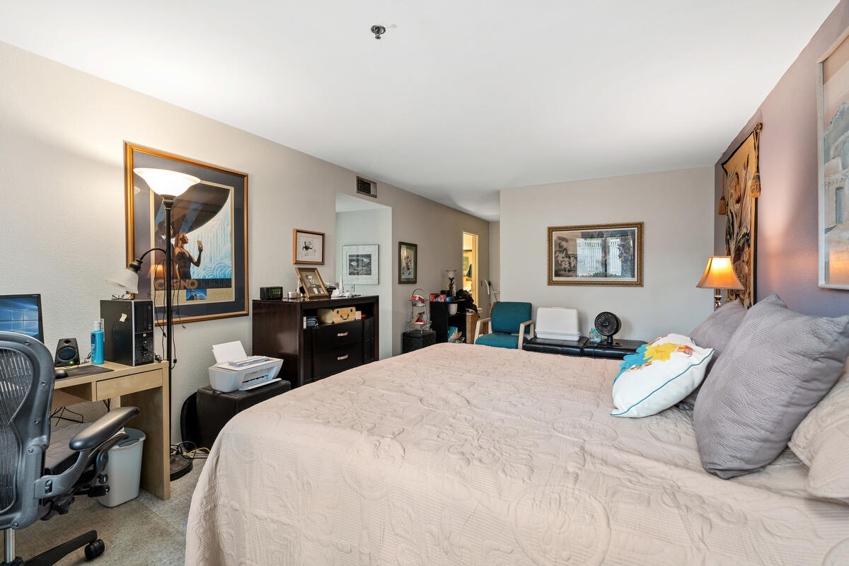 200 East Racquet Club Road, Unit 69 Palm Springs, CA 92262 - Photo 21 of 44 a bedroom with a bed and wooden floor