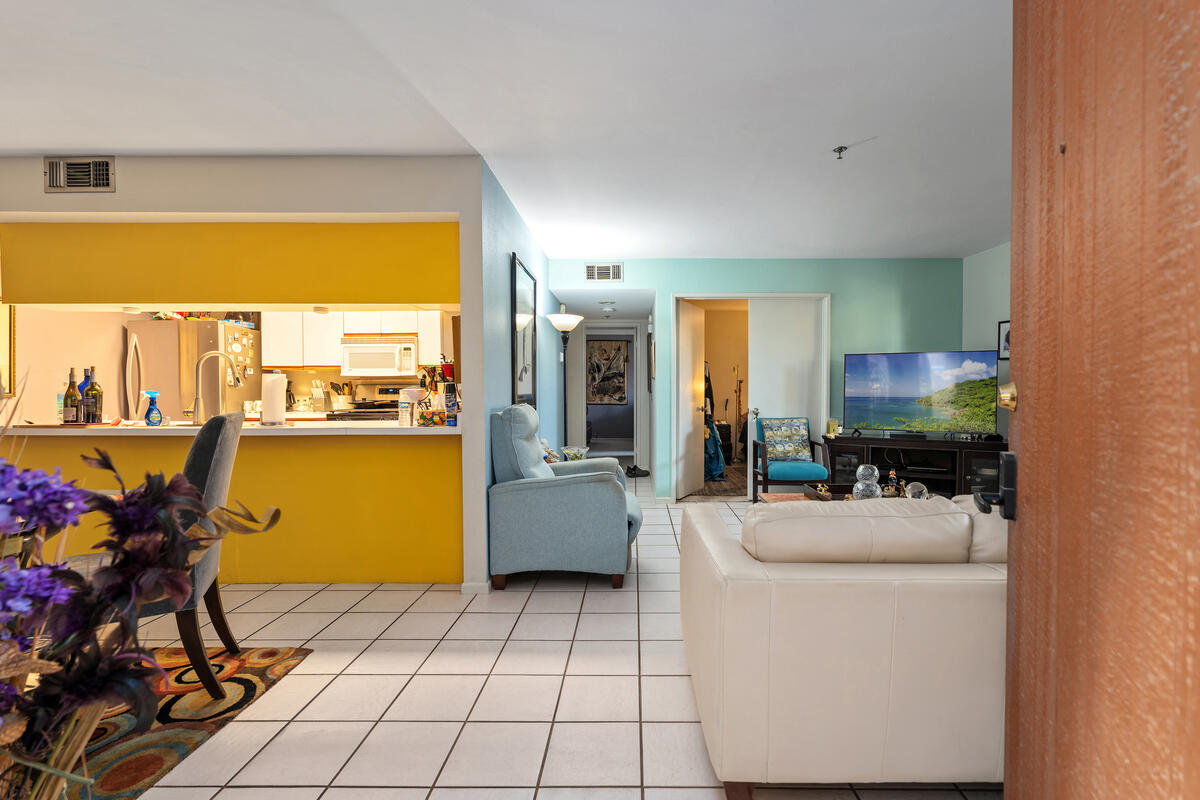 200 East Racquet Club Road, Unit 69 Palm Springs, CA 92262 - Photo 5 of 44 a room with furniture a large window and storage space