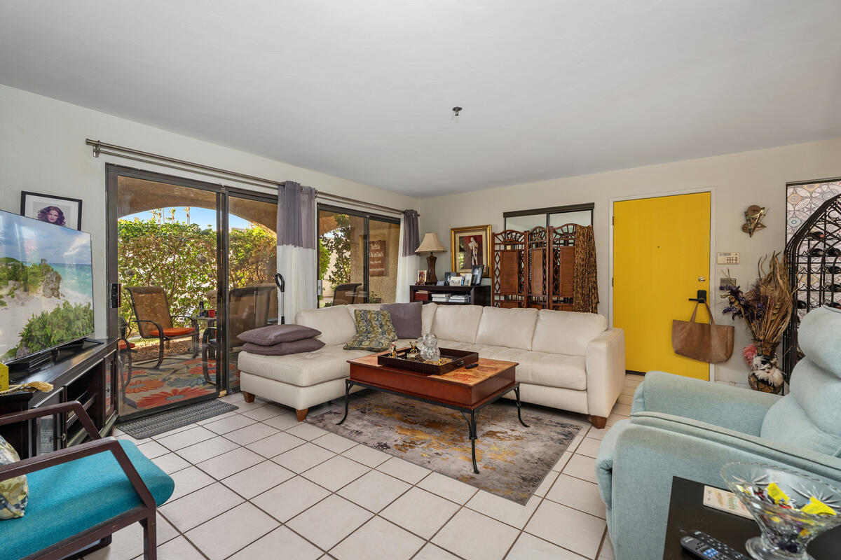 200 East Racquet Club Road, Unit 69 Palm Springs, CA 92262 - Photo 7 of 44 a living room with furniture and a flat screen tv