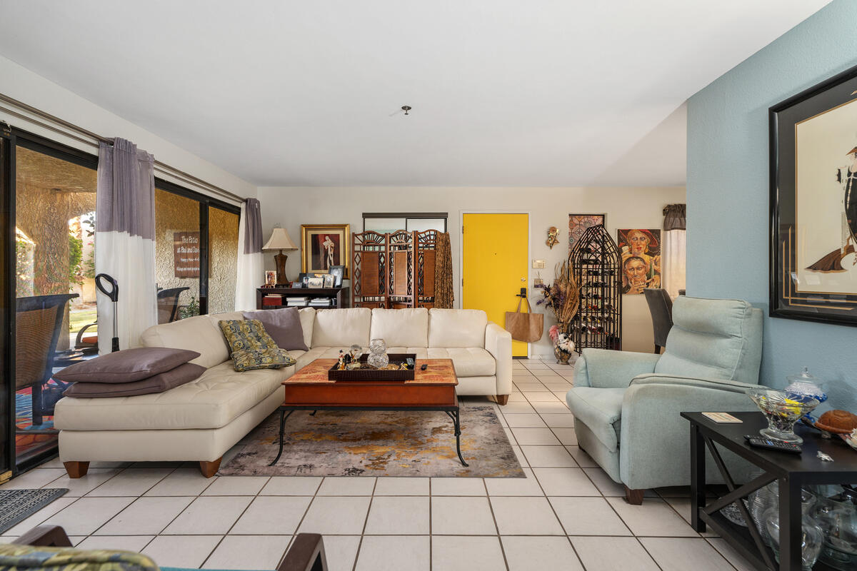 200 East Racquet Club Road, Unit 69 Palm Springs, CA 92262 - Photo 8 of 44 a living room with furniture and a flat screen tv
