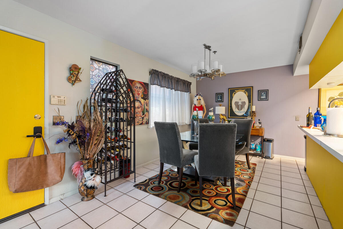 200 East Racquet Club Road, Unit 69 Palm Springs, CA 92262 - Photo 9 of 44 a view of a dining room with furniture and chandelier