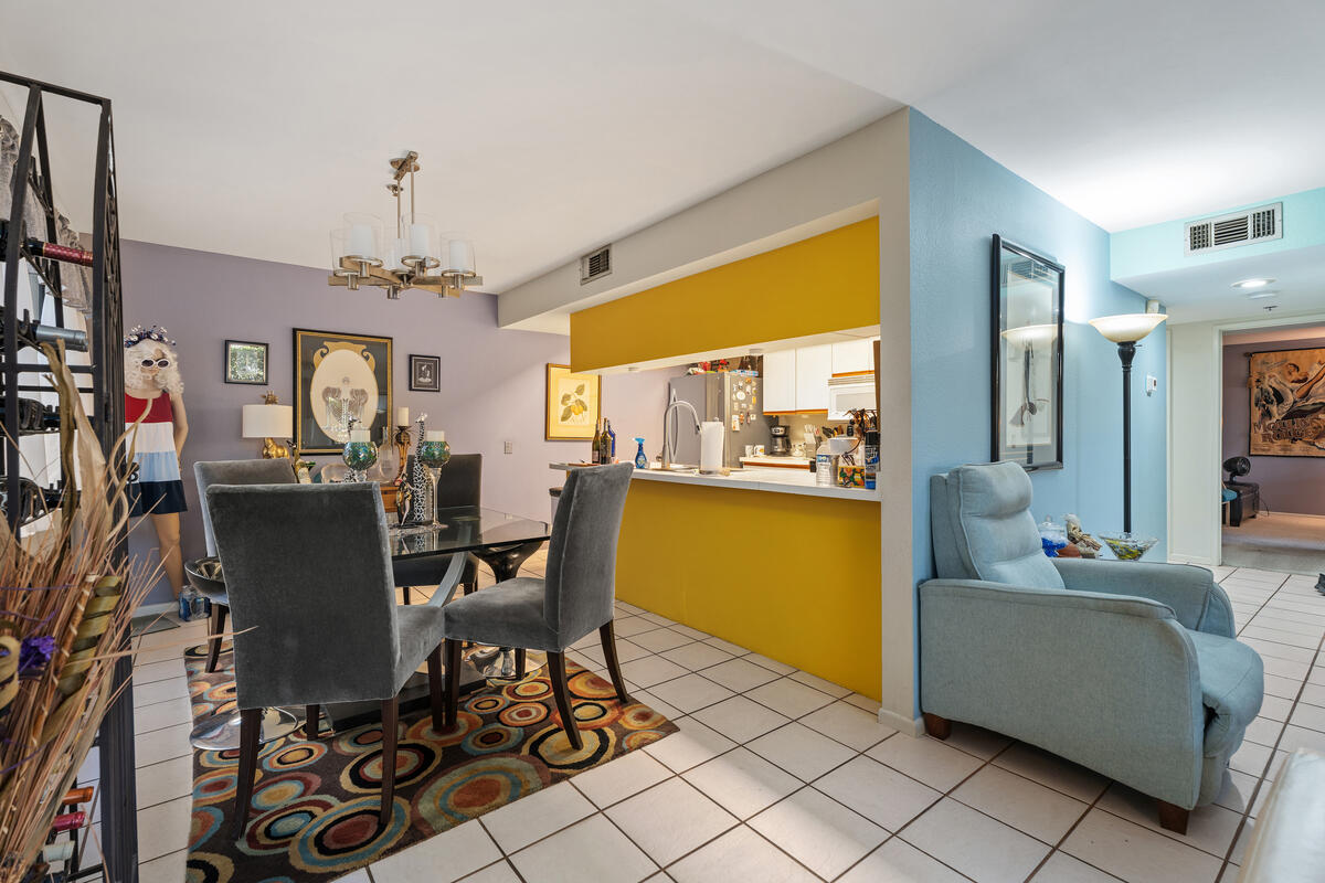 200 East Racquet Club Road, Unit 69 Palm Springs, CA 92262 - Photo 10 of 44 a view of a dining room with furniture and a chandelier