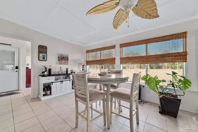 a view of a dining room with furniture and a potted plant