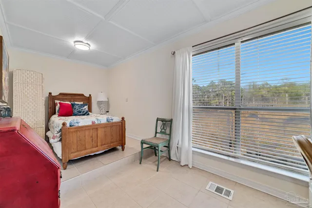 a bedroom with furniture and a window