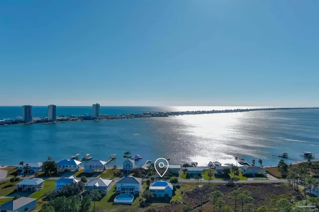 a view of a lake with lawn chairs and a fountain