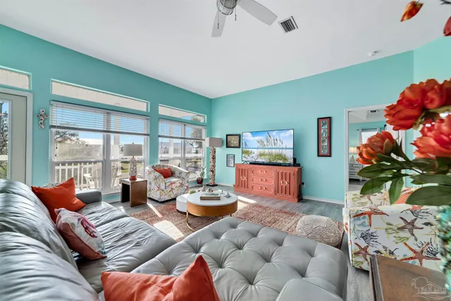 a living room with furniture and a floor to ceiling window