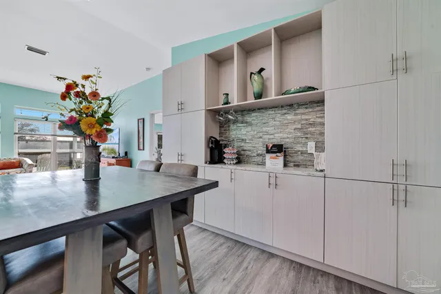 a kitchen with stainless steel appliances cabinets and wooden floor