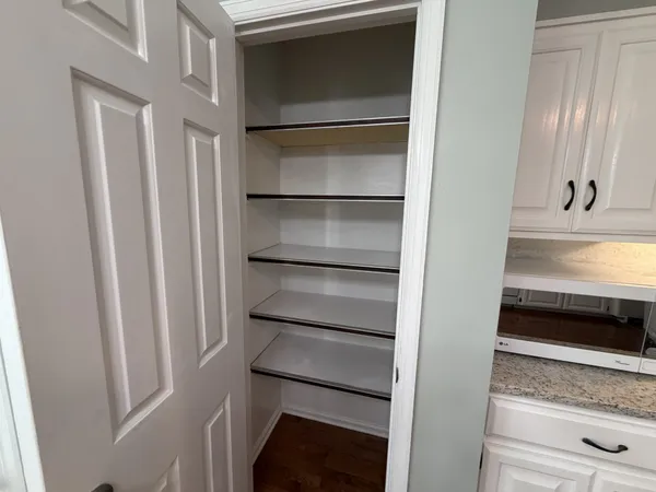 a view of an empty room and wooden floor