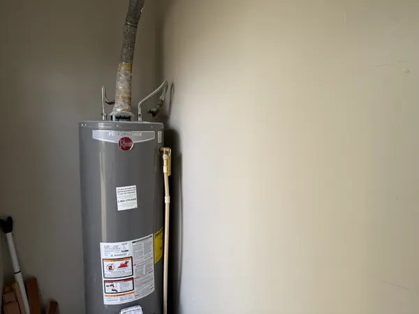 an empty room with wooden floor fireplace and windows