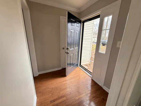 a view of entryway with wooden floor and stairs