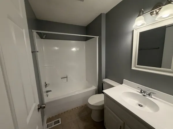 an empty room with wooden floor and fireplace