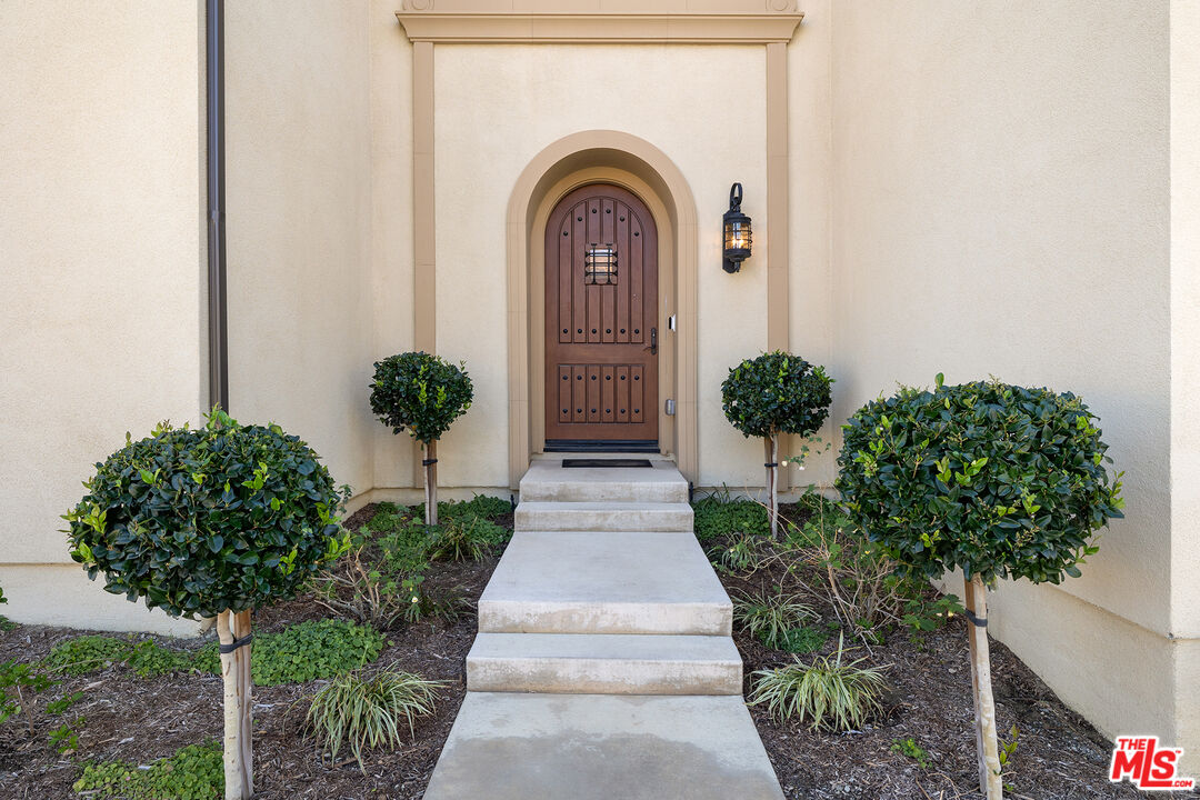 20234 Jubilee Way Porter Ranch, CA 91326 - Photo 5 of 30 a front view of a house with garden