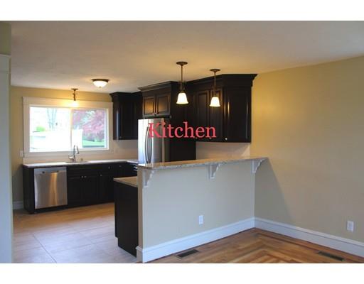 a kitchen with cabinets and window