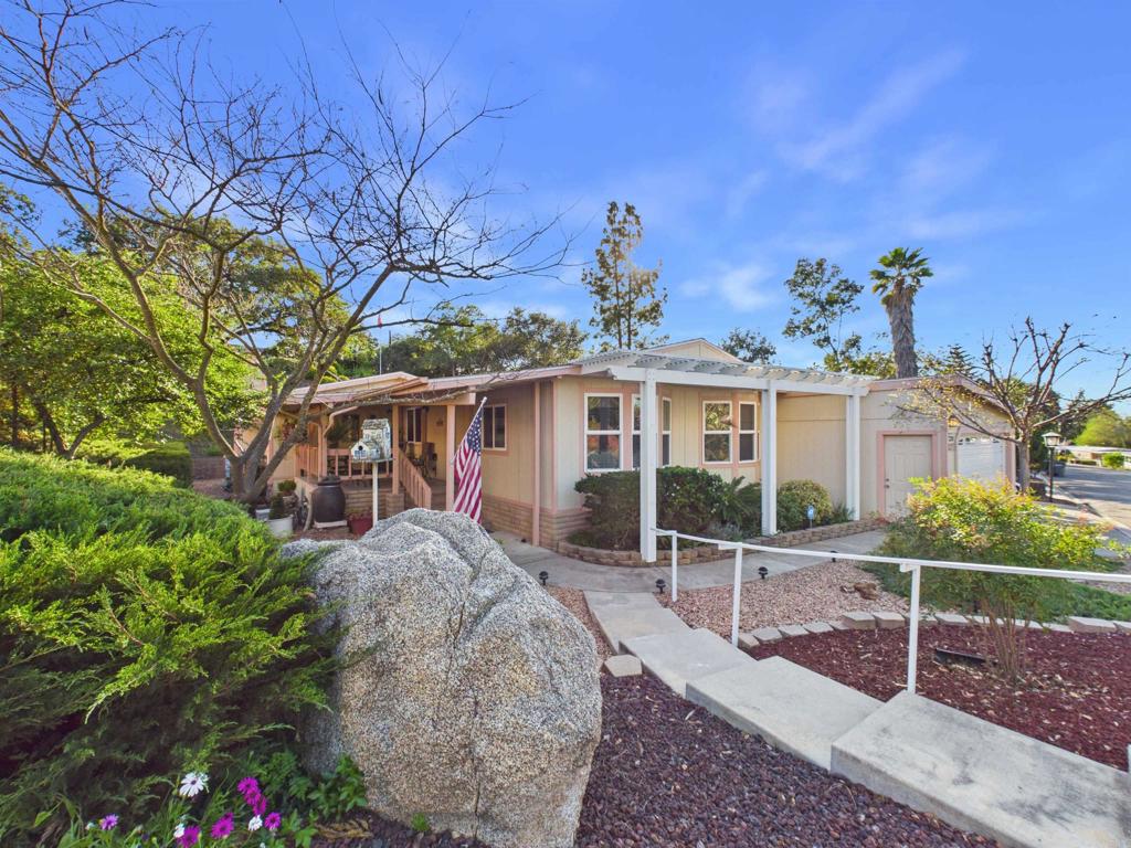 18218 Paradise Mountain Road, Unit 220 Valley Center, CA 92082 - Photo 2 of 48 front view of a house with a yard