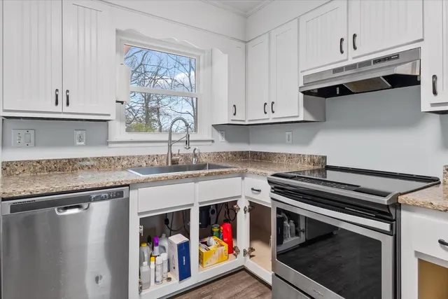 a kitchen with stainless steel appliances granite countertop a stove and a sink