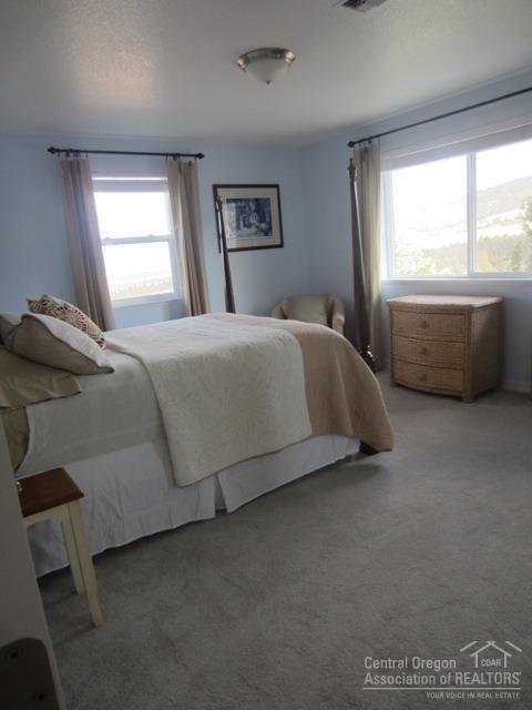 8188 Southwest Ridge Lane Powell Butte, OR 97753 - Photo 15 of 25 a bedroom with a bed and window