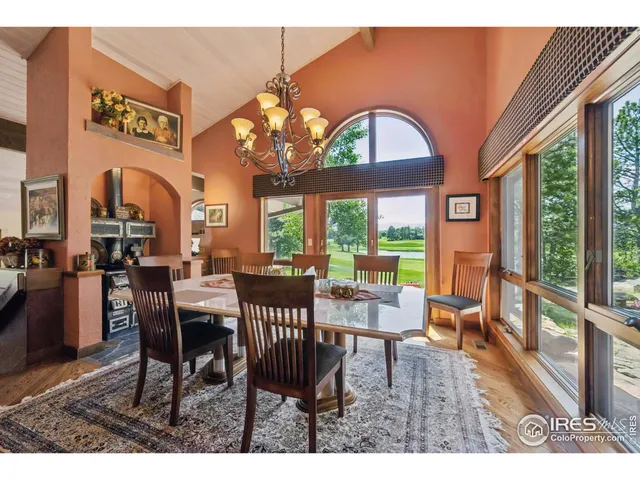 a view of a dining room with furniture wooden floor and chandelier