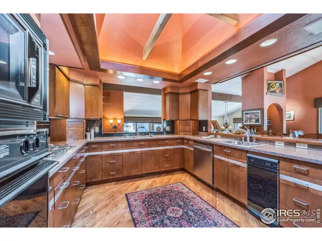 a kitchen with stainless steel appliances kitchen island granite countertop a sink and cabinets