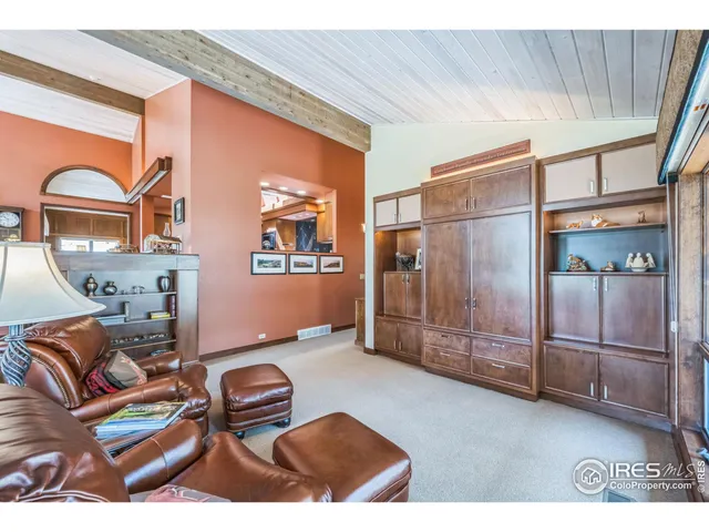 a living room with furniture a rug and a large window