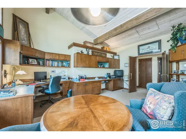a living room with furniture and large windows