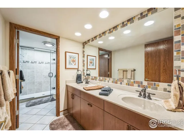 a bedroom with a bed a chandelier and dresser