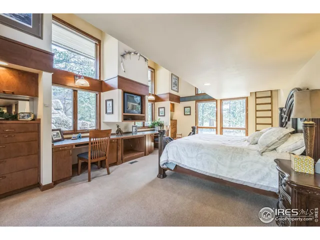 a bedroom with furniture and a large window