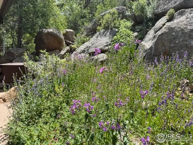 an aerial view of a house with outdoor seating