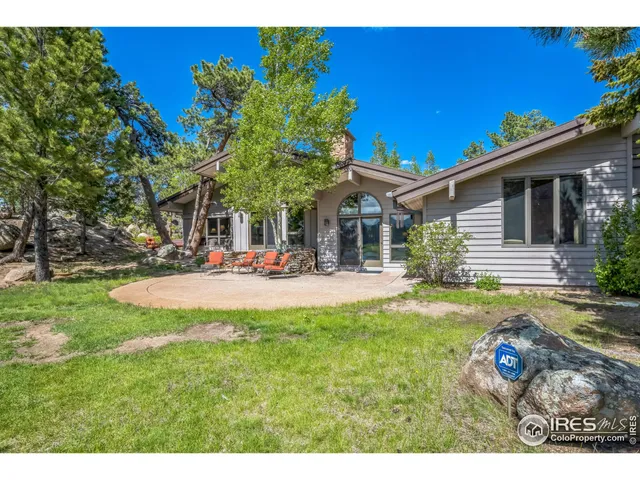 a swimming pool with outdoor seating and yard