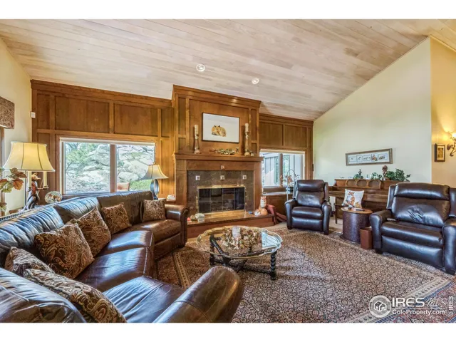 a living room with furniture large window and flat screen tv