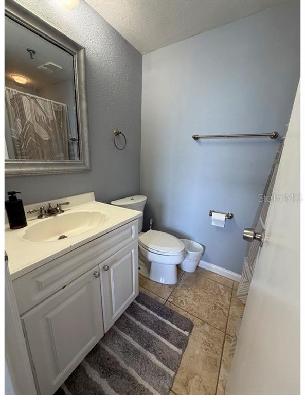 6165 Carrier Drive, Unit 1903 Orlando, FL 32819 - Photo 13 of 21 a bathroom with a sink and a mirror