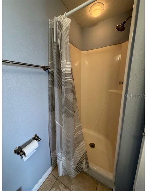 6165 Carrier Drive, Unit 1903 Orlando, FL 32819 - Photo 14 of 21 a bathroom with a shower