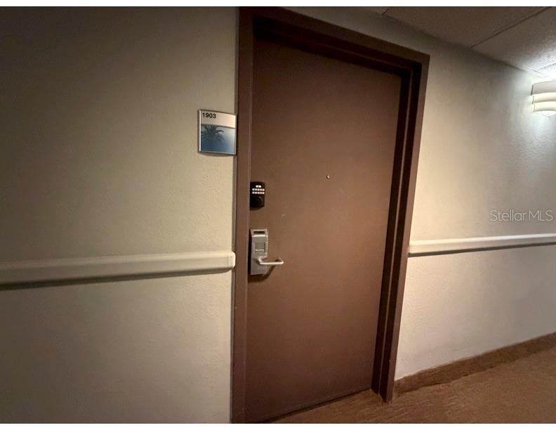 6165 Carrier Drive, Unit 1903 Orlando, FL 32819 - Photo 18 of 21 a bathroom with a glass shower door