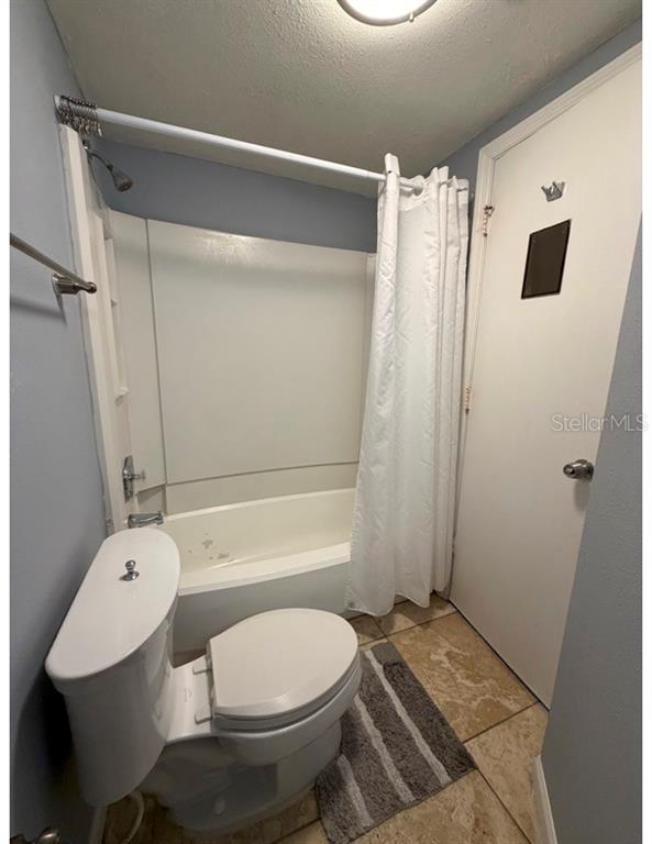 6165 Carrier Drive, Unit 1903 Orlando, FL 32819 - Photo 10 of 21 a bathroom with a toilet and a shower