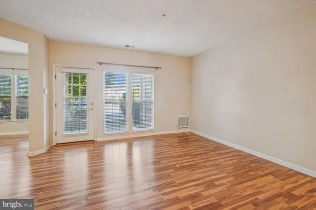 a kitchen with stainless steel appliances a stove a sink a microwave a refrigerator and cabinets