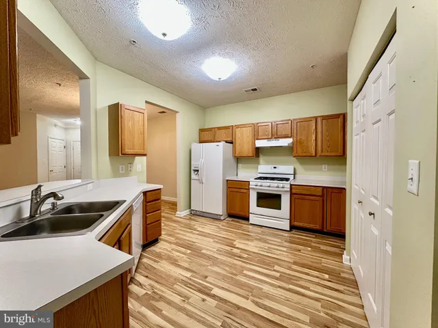 a kitchen with a refrigerator and a sink