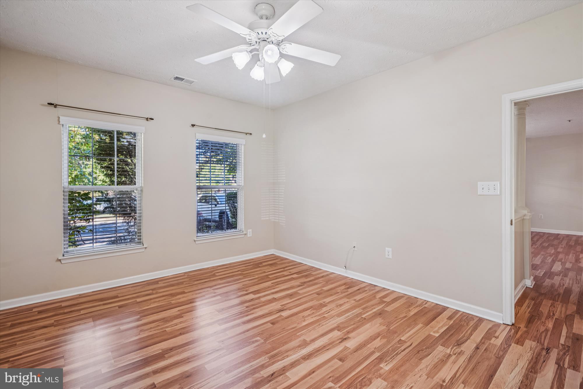 2412 Chestnut Terrace Court, Unit 104 Odenton, MD 21113 - Photo 16 of 42 a view of an empty room with wooden floor and a window