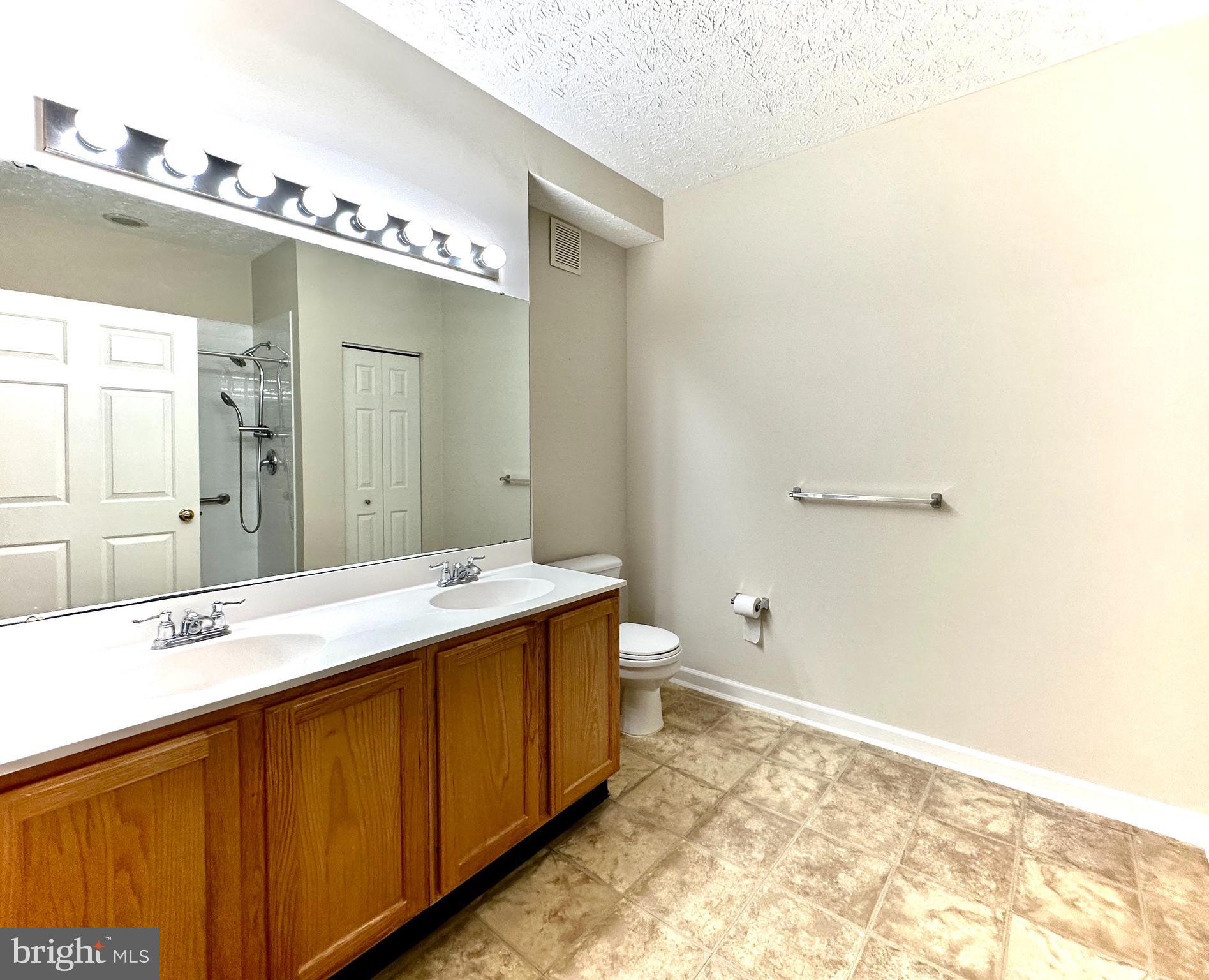 2412 Chestnut Terrace Court, Unit 104 Odenton, MD 21113 - Photo 17 of 42 a bathroom with a sink and mirror