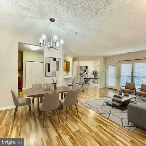 a living room with lots of furniture and a chandelier