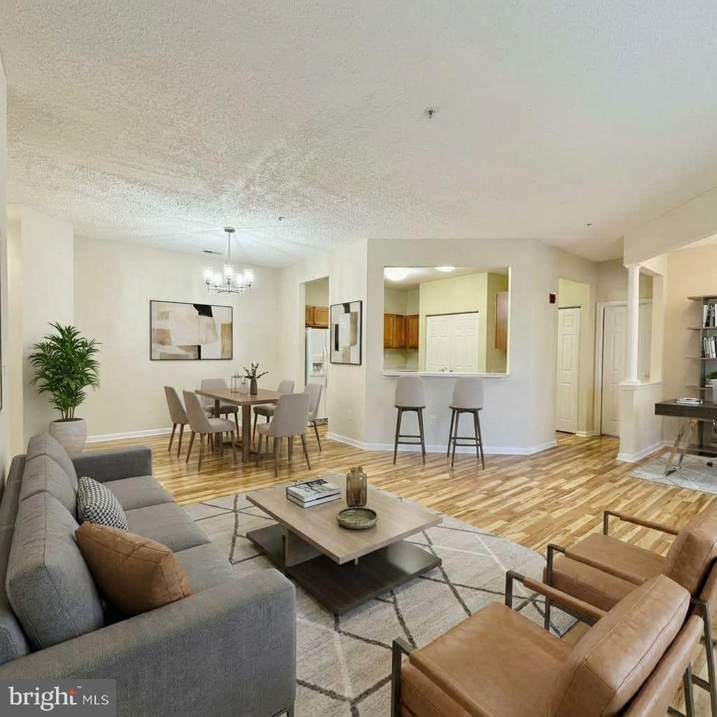 2412 Chestnut Terrace Court, Unit 104 Odenton, MD 21113 - Photo 3 of 42 a living room with furniture and wooden floor