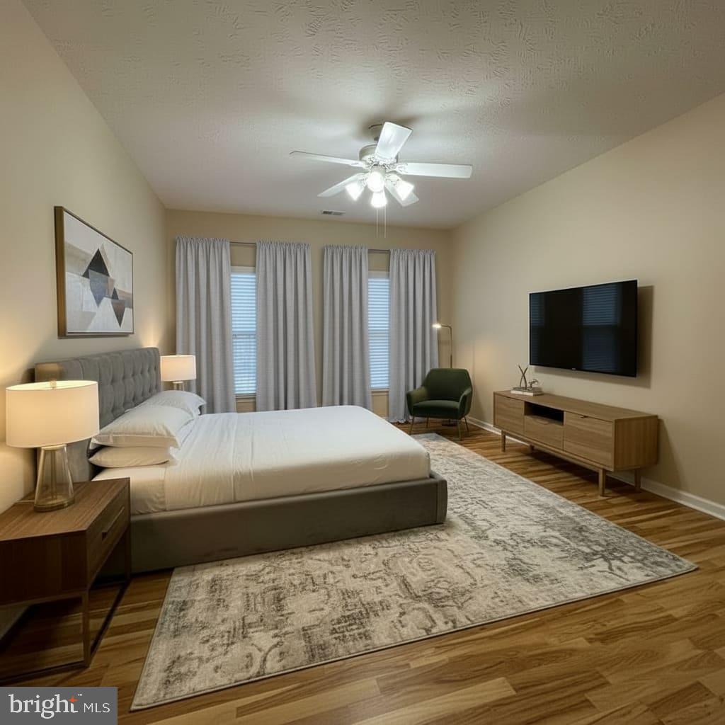 2412 Chestnut Terrace Court, Unit 104 Odenton, MD 21113 - Photo 4 of 42 a bedroom with a bed and a flat screen tv