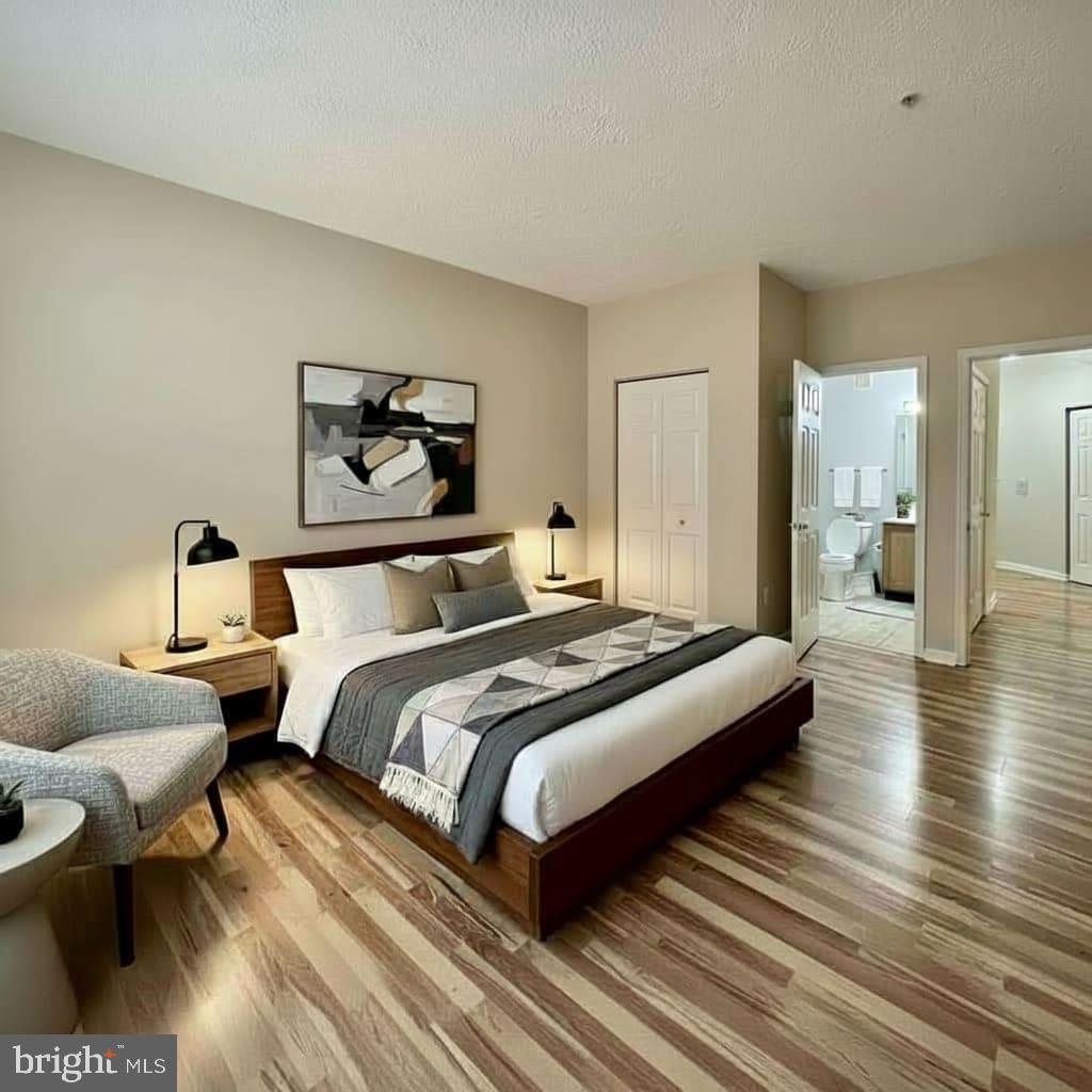 2412 Chestnut Terrace Court, Unit 104 Odenton, MD 21113 - Photo 6 of 42 a bedroom with bed a mirror and a table