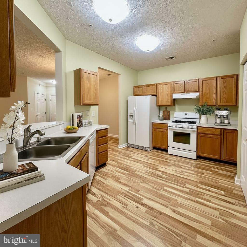 2412 Chestnut Terrace Court, Unit 104 Odenton, MD 21113 - Photo 7 of 42 a kitchen with a sink stove and refrigerator