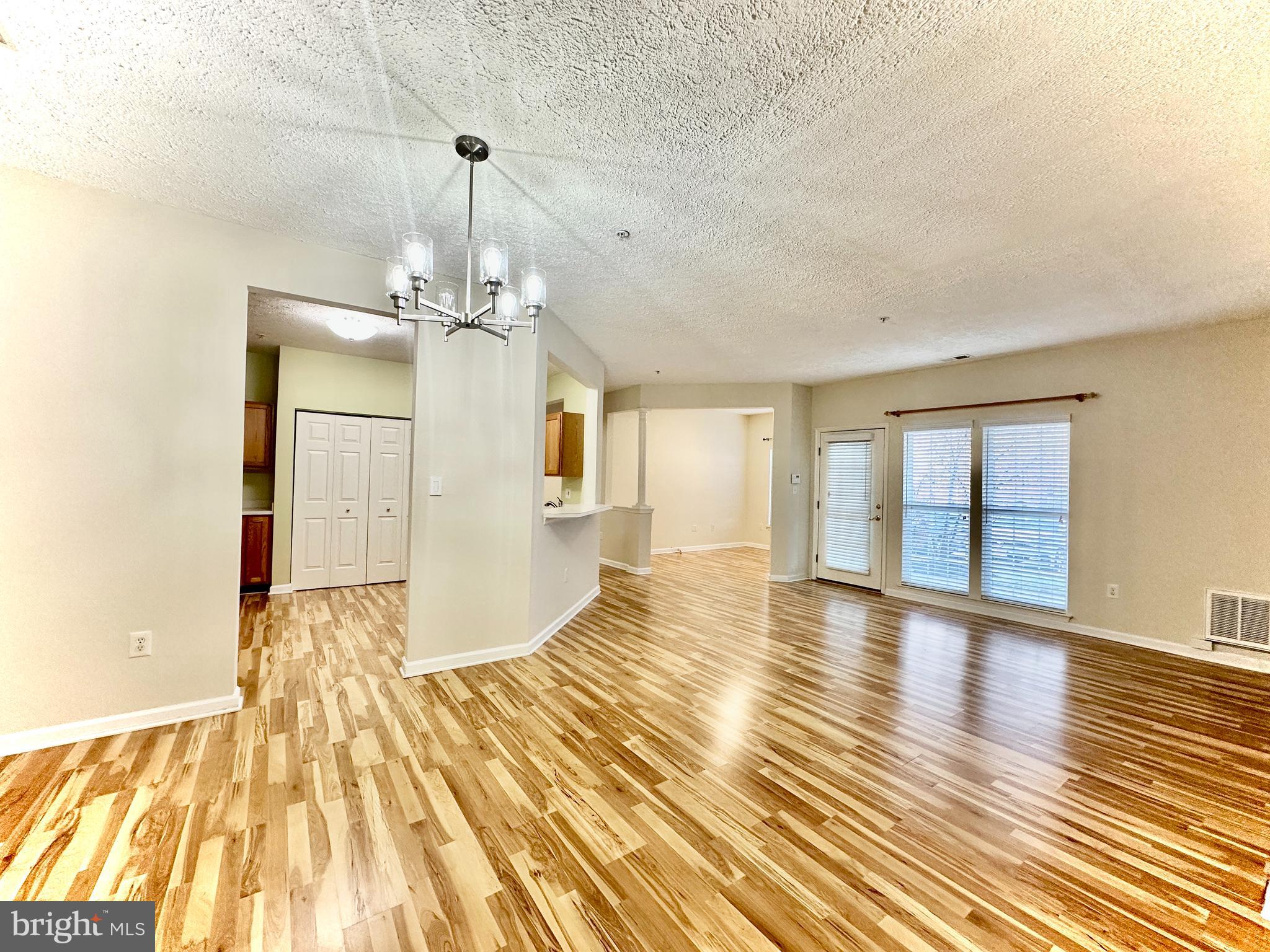 2412 Chestnut Terrace Court, Unit 104 Odenton, MD 21113 - Photo 10 of 42 a view of a room with wooden floor and windows