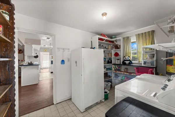 a kitchen view with refrigerator and cabinets