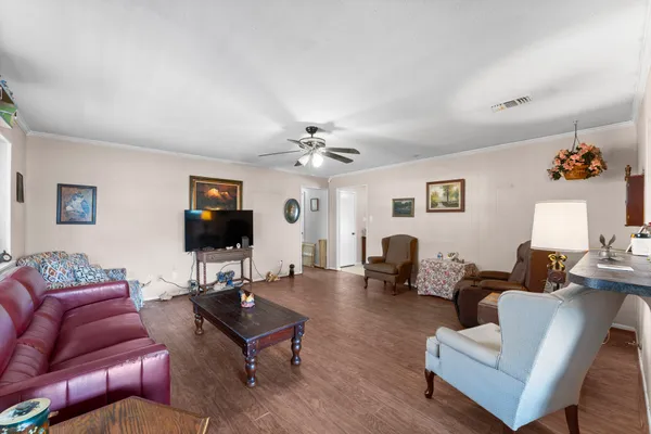 a living room with furniture a flat screen tv and a window