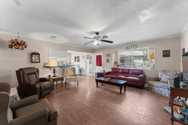 a living room with furniture and wooden floor