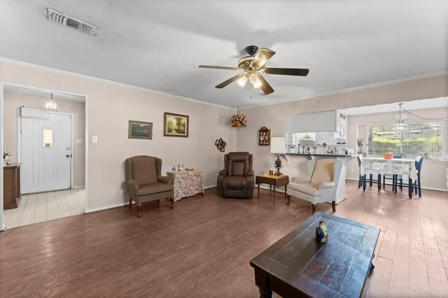 a living room with furniture and wooden floor