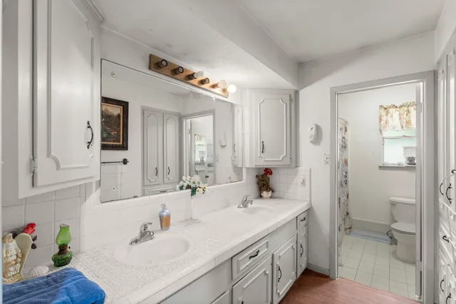 a spacious bathroom with a shower sink and mirror