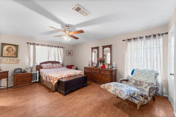 a bedroom with a bed and a chandelier